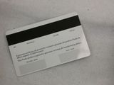 a black and white picture of a cell phone and a credit card