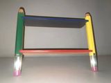 a small wooden stool made out of colored pencils