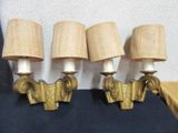 three lamps that are on the wall next to each other