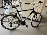 a bike that is parked in a room next to a mirror