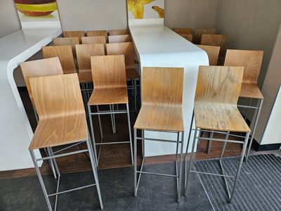 many wooden chairs and a table in a room