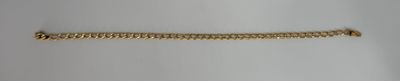 a close up of a gold chain on a white surface