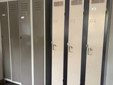 several lockers are lined up in a room with tile flooring