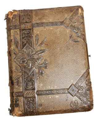 an old book with a decorative design on the cover
