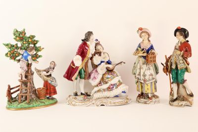 five figurines of people in different styles and colors