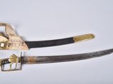 pair of old and worn swords on a white surface