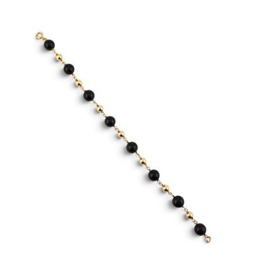 un bracelet composé de perles dorées et noires sur fond blanc
