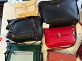 a lot of purses that are on a table