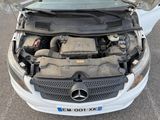 a mercedes benz car with its hood open and the engine in the trunk
