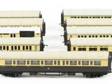 four model trains are lined up in a row on a white surface