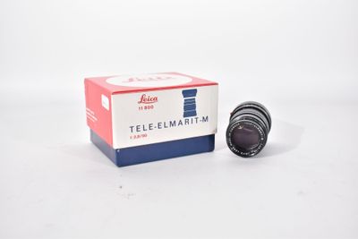 a close up of a camera lens in a box on a white surface