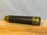 un vieux télescope noir et en laiton posé sur une table en bois