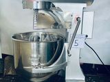 a mixer that is sitting on a stand in the kitchen