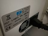 an electric charger plugged into the wall of a bathroom