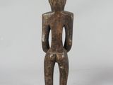an image of a wooden statue of a person sitting on a stool