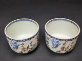 pair of blue and white bowls with floral designs on them