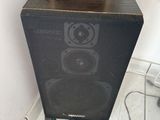 a speaker that is sitting on top of a cabinet