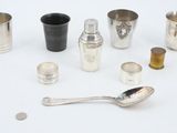 a lot of silver cups and spoons on the table
