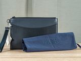 a black purse and a blue case sitting on top of a wooden table