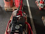 a red machine that is sitting on a pallet in a warehouse