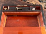 a wooden box with a key in it on a table