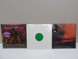three cd ' s with a green disc on top of them