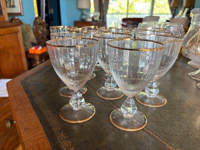 several empty wine glasses sitting on top of a wooden table