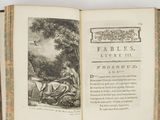 an open book with a picture of a man and a woman sitting on a bench