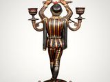 an image of a statue of a man holding two candles