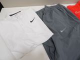 three pairs of men ' s nike tennis clothing on a white table
