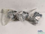 a bunch of screws are wrapped in plastic bags on a table