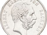 an old silver coin with a man ' s face on it