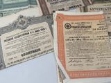 many different types of old paper money on the table