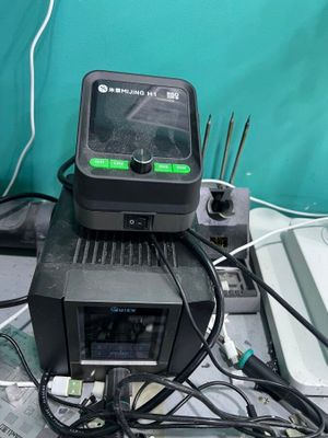 a small black device sitting on top of a pile of wires