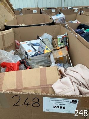 a cardboard box full of clothes and other items in it