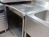 a stainless steel sink and a microwave in a kitchen