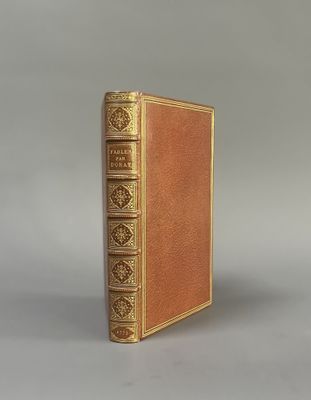 an old book sitting on top of a table next to a gray background