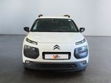 a white car that is parked in a room
