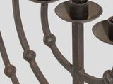 a large metal menorah that has five candles on it