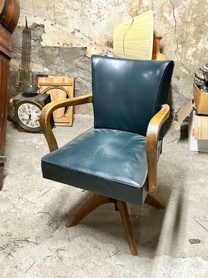a chair that is sitting in a room with a clock