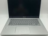 a laptop computer sitting on top of a white table