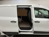 a white van with its doors open in a garage
