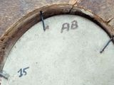 a close up of a clock on a piece of wood