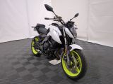 a picture of a white and yellow motorcycle parked on a black and white checkered floor