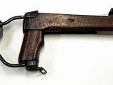 an old style gun with a wooden handle on a white surface
