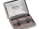 two silver cuff rings in a box on a white background