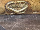 a close up of a piece of wood with a brass plate on it