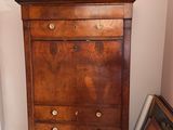 a wooden chest of drawers with a bowl on top of it