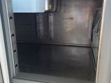 a silver oven with a door open on a kitchen counter