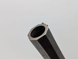 close up of a metal tube on a white background